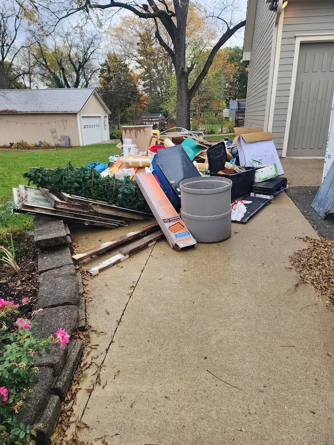 Dumpster being loaded with debris for Estate Cleanout Dumpster Rental in El Dorado